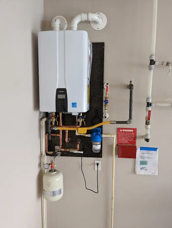 Professional plumber installing copper piping in a Robbinsdale home